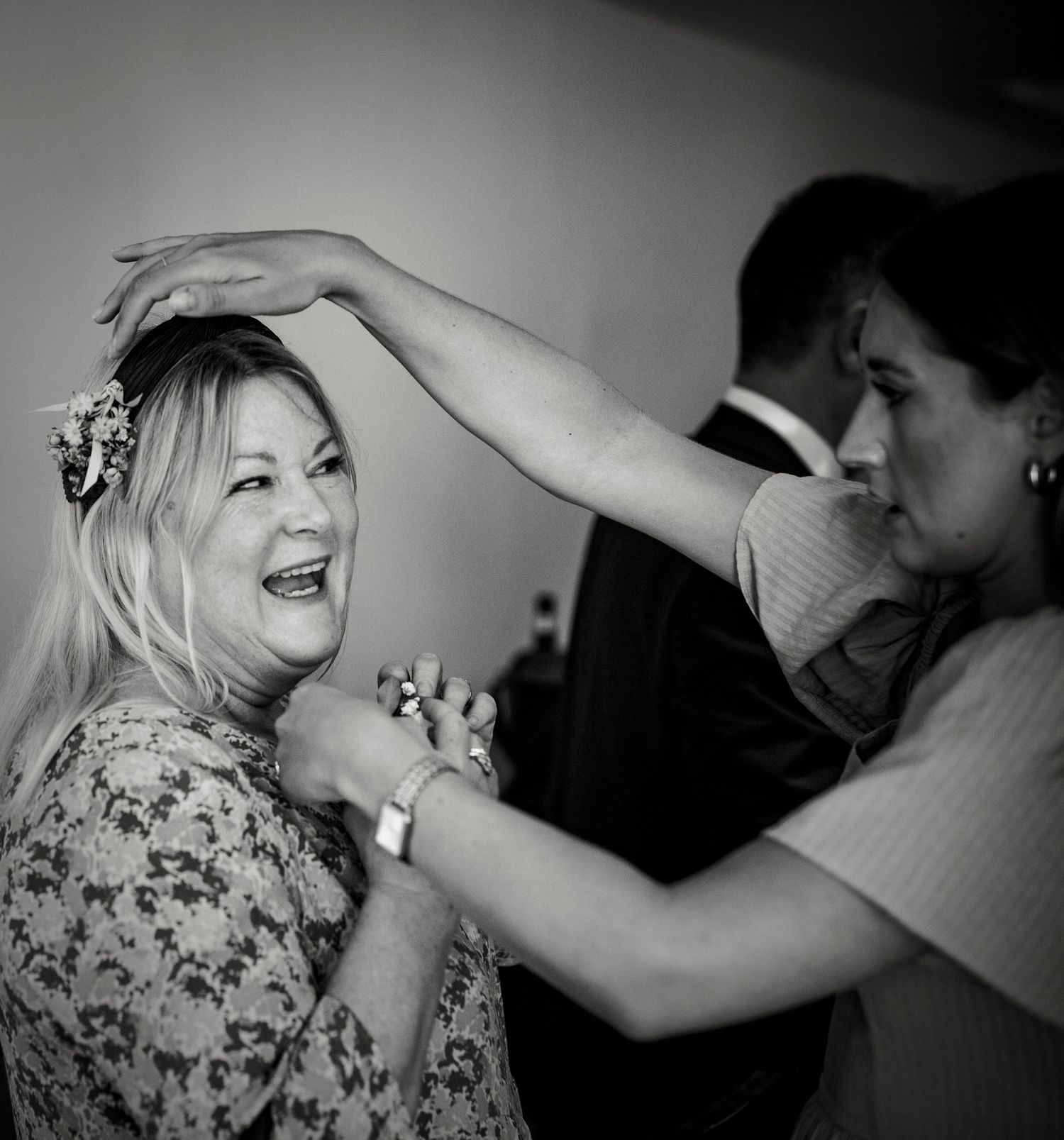 Black and white candid shots of wedding makeup application in dramatic lighting.
