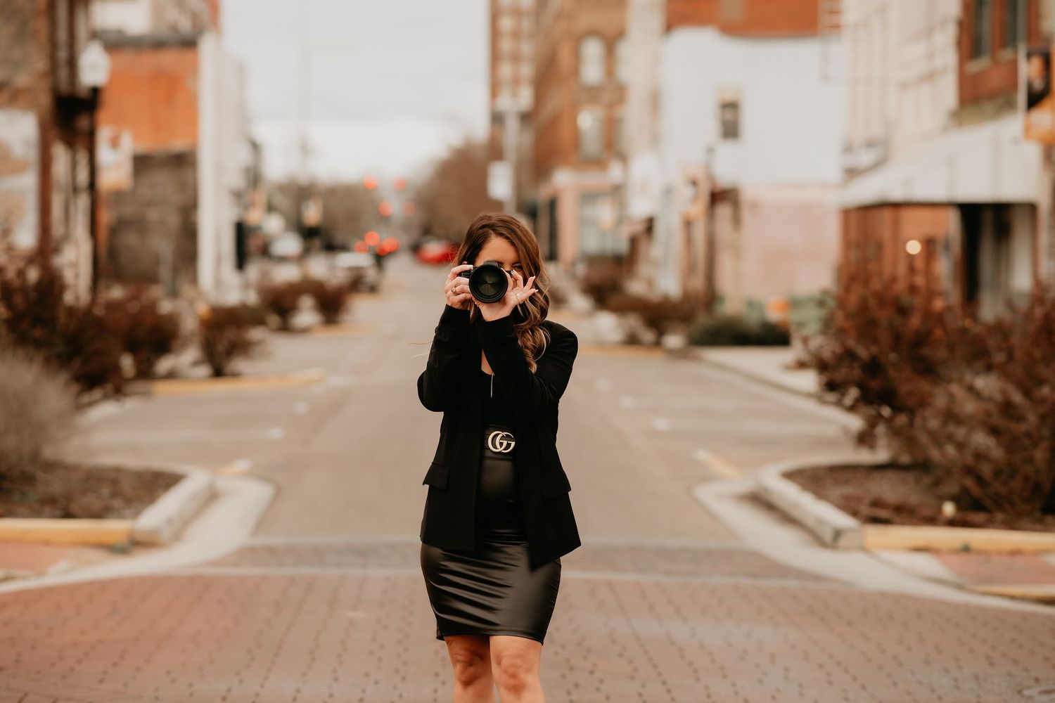 A beautiful woman, the photographer, showing her lens where she makes all her magic.