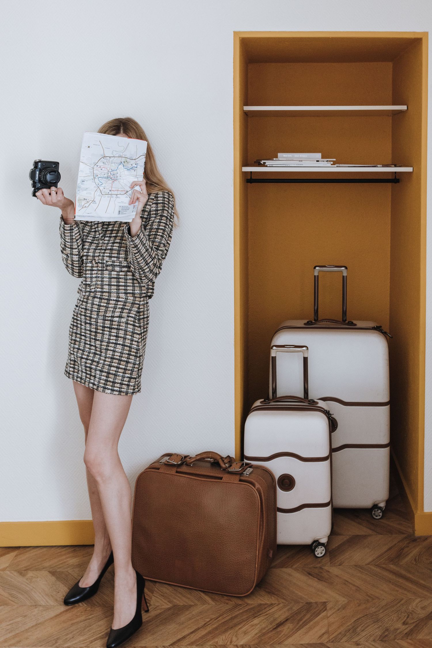Travel luggage and suitcases arranged in wooden closet storage space.