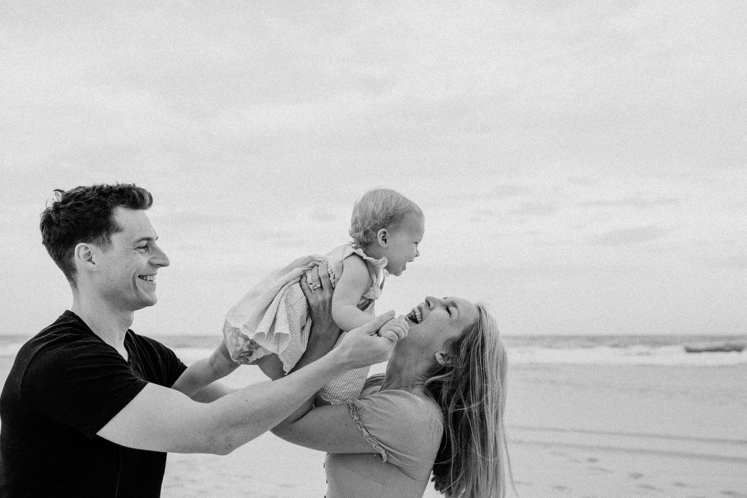 Mother and child embracing with joy, set against the beautiful Gold Coast coastline