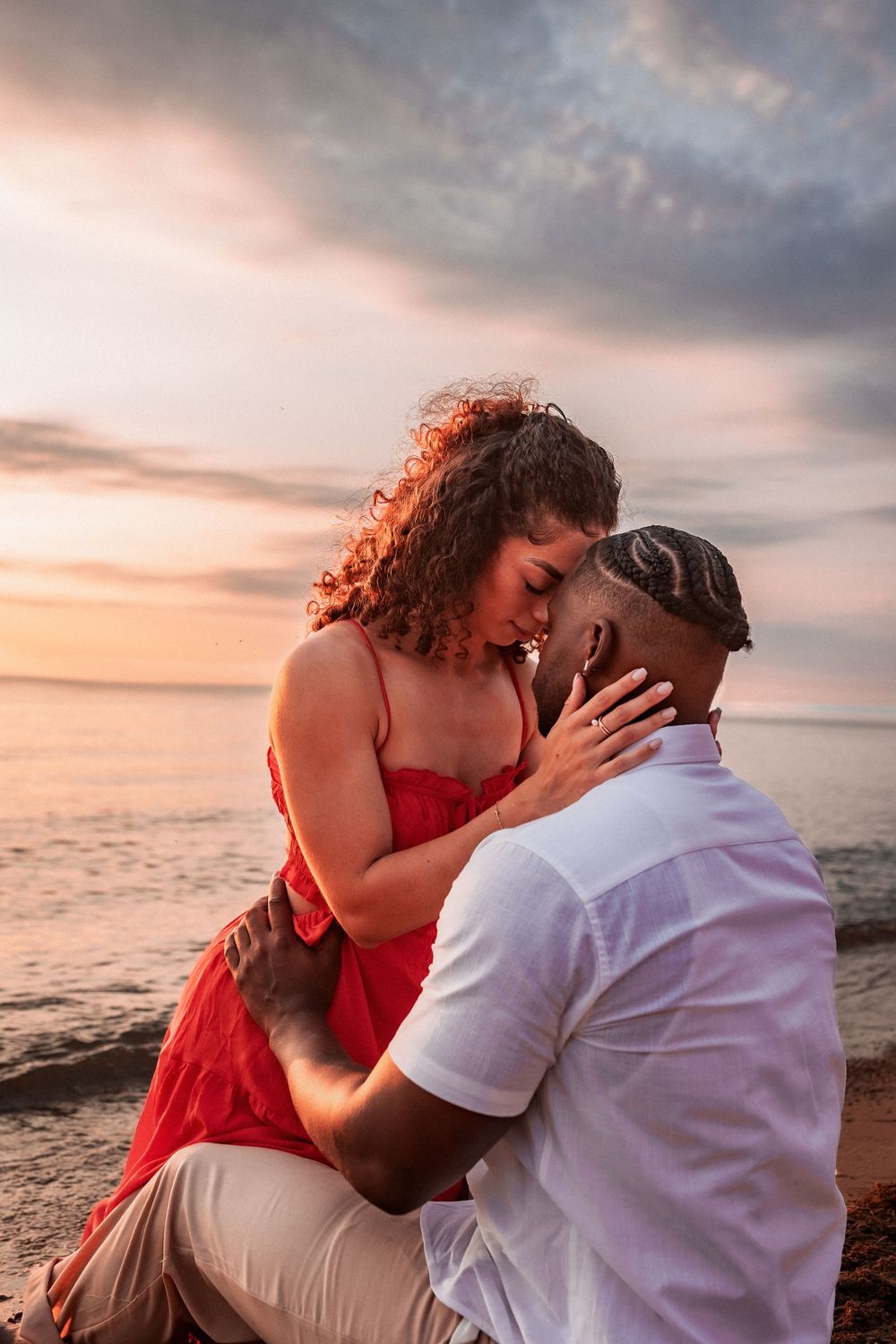 Intimate couple portrait during golden hour sunset at the beach.