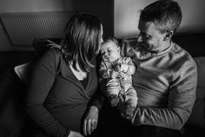 Black and white photo series showing tender moments between parent and child in intimate close-up shots.