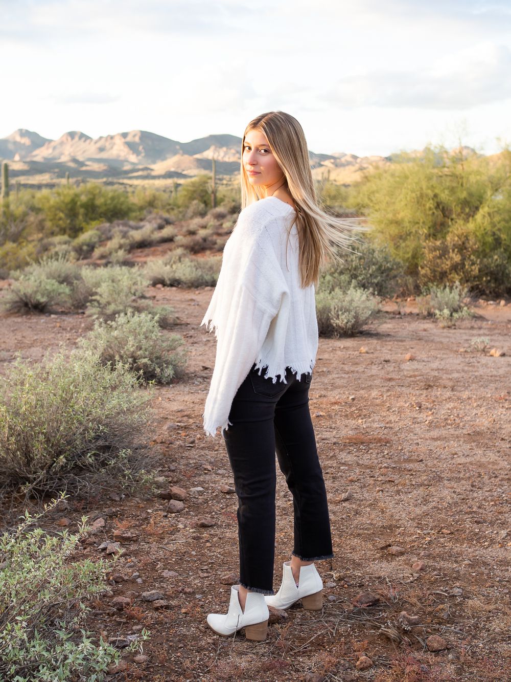 girl standing in desert and wearing fashionable boots. senior photos Sonoma County