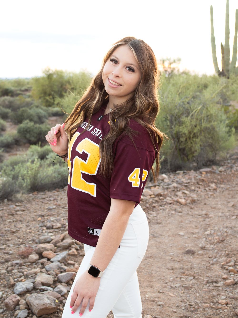 girl standing in desert and wearing football jersey. senior photos Sonoma County