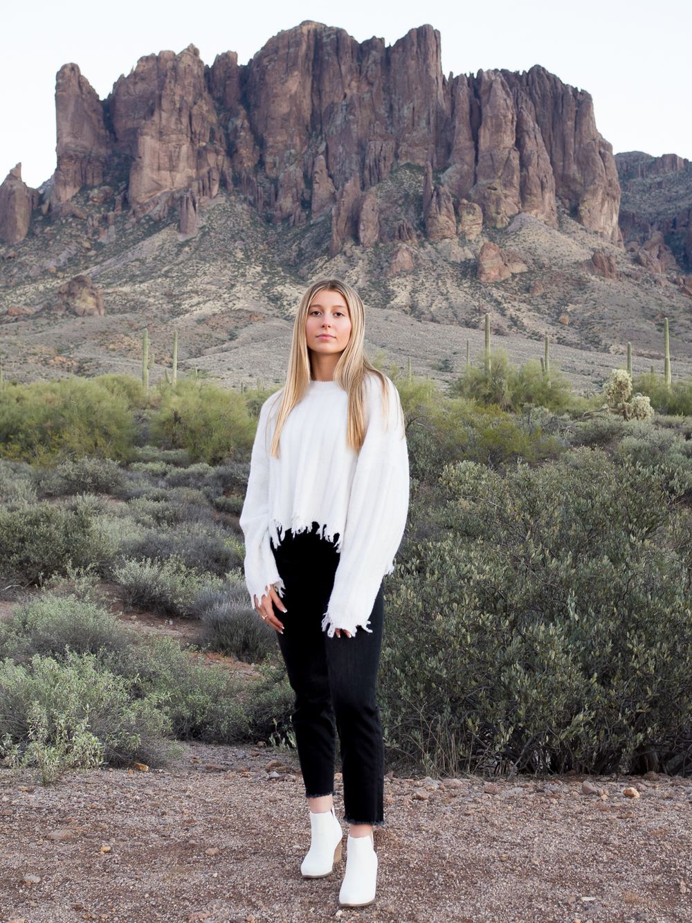 girl standing in front of a mountain and wearing fashionable boots. senior photos Sonoma County
