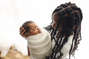 sibling looking at baby during newborn session