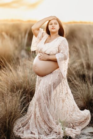 woman at outdoor sunset maternity session