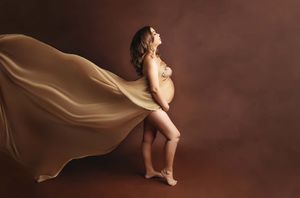 woman with flowing fabric at maternity session