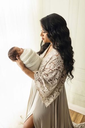 mother looking at baby during newborn photoshoot
