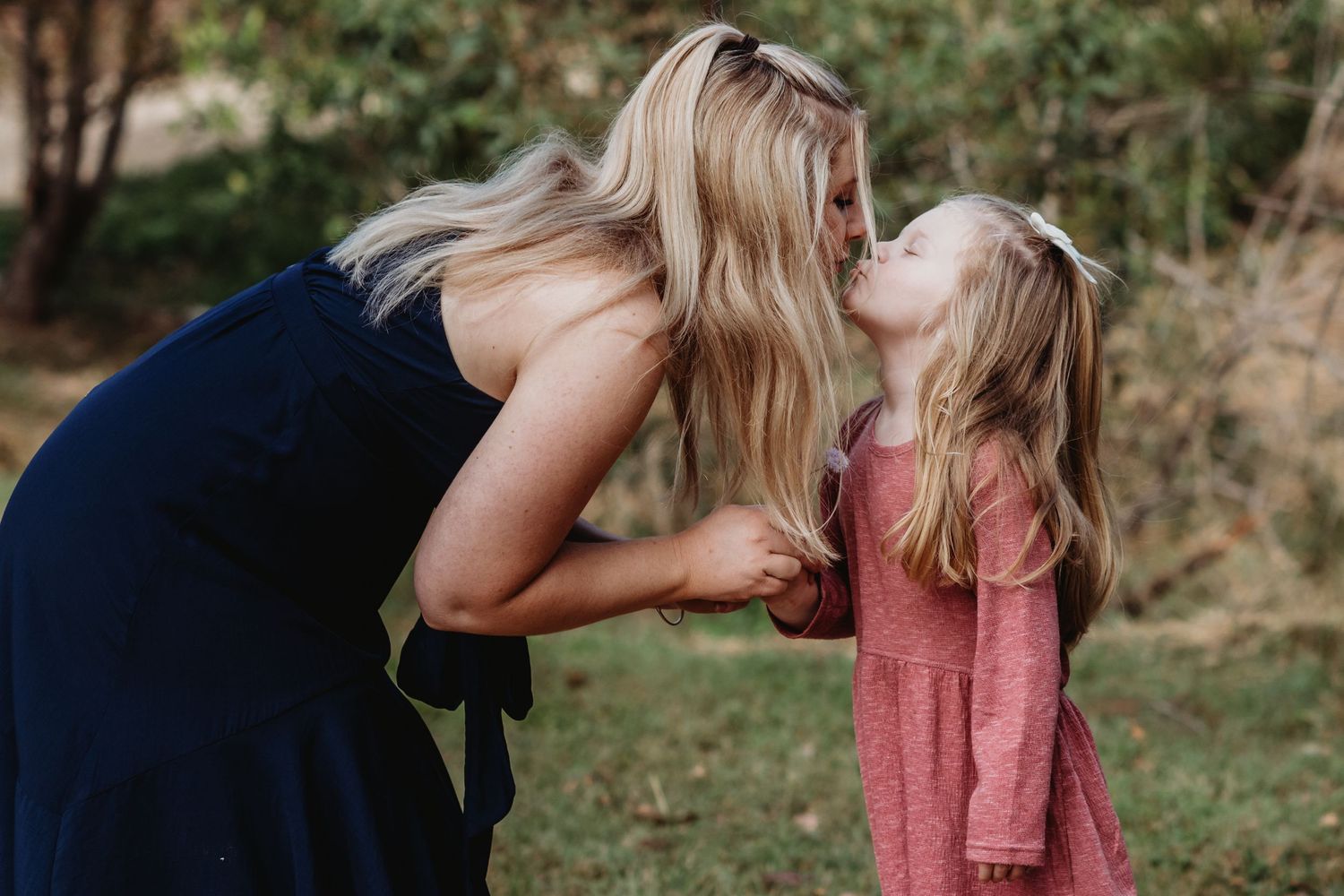 A tender moment shared outdoors on a sunny autumn day.