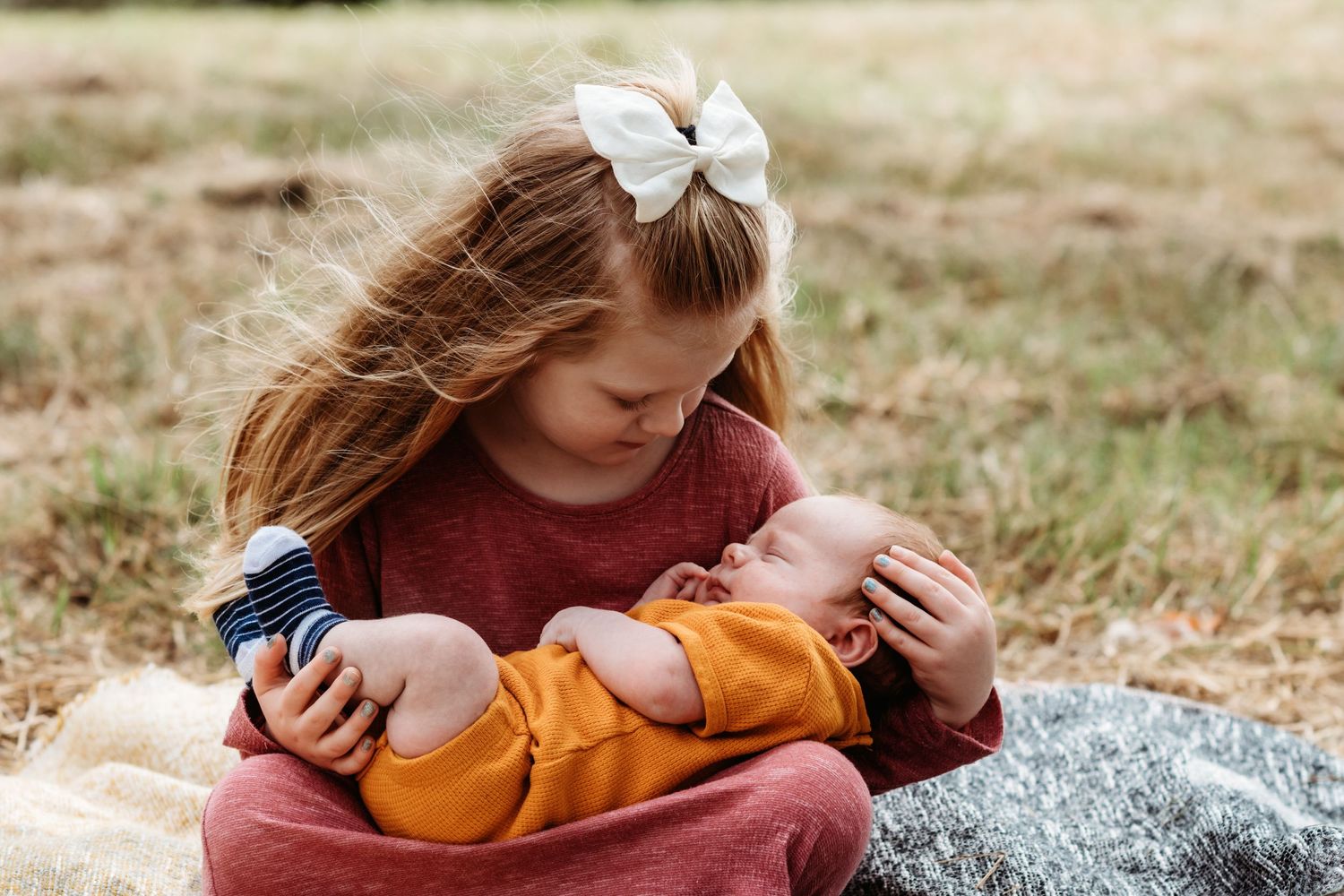 Peaceful outdoor scene of playing with toys on a cozy blanket in natural lighting.