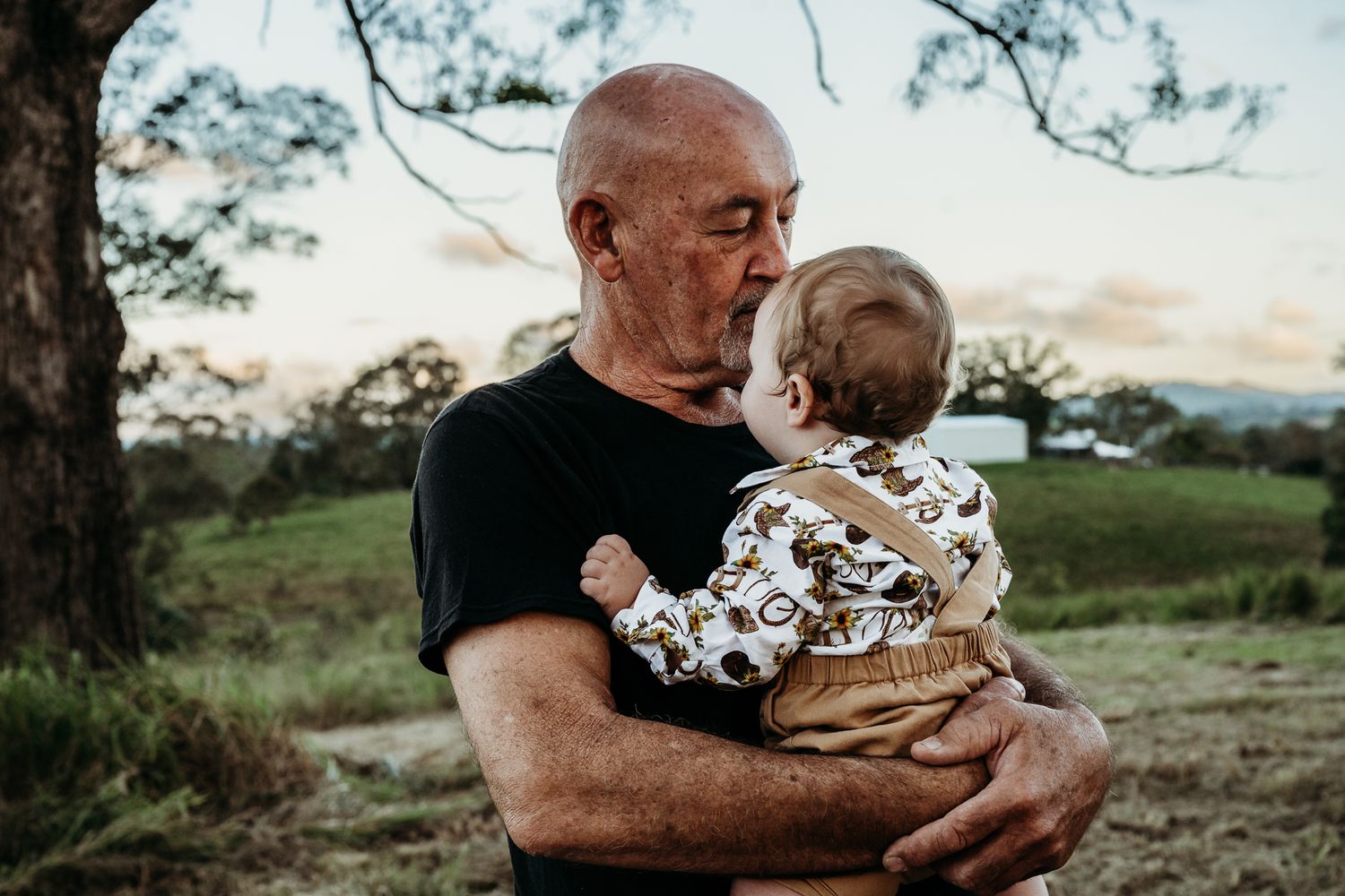 A heartwarming outdoor embrace against a scenic natural backdrop.