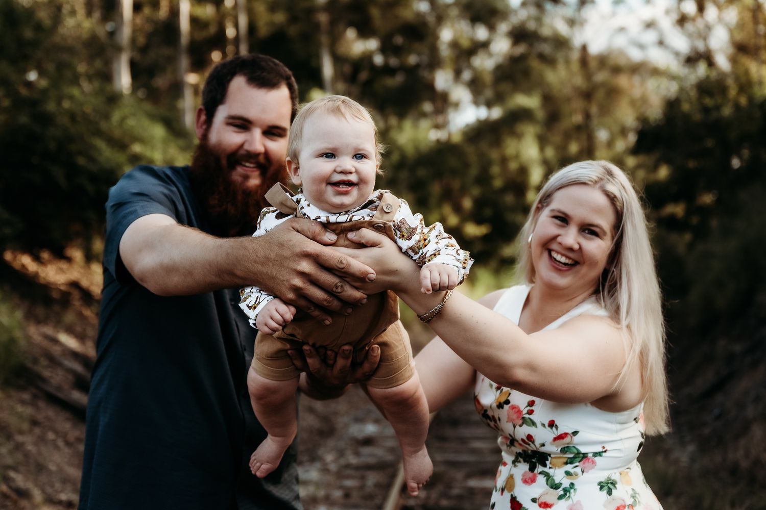 Happy family moment captured outdoors in natural sunlight.