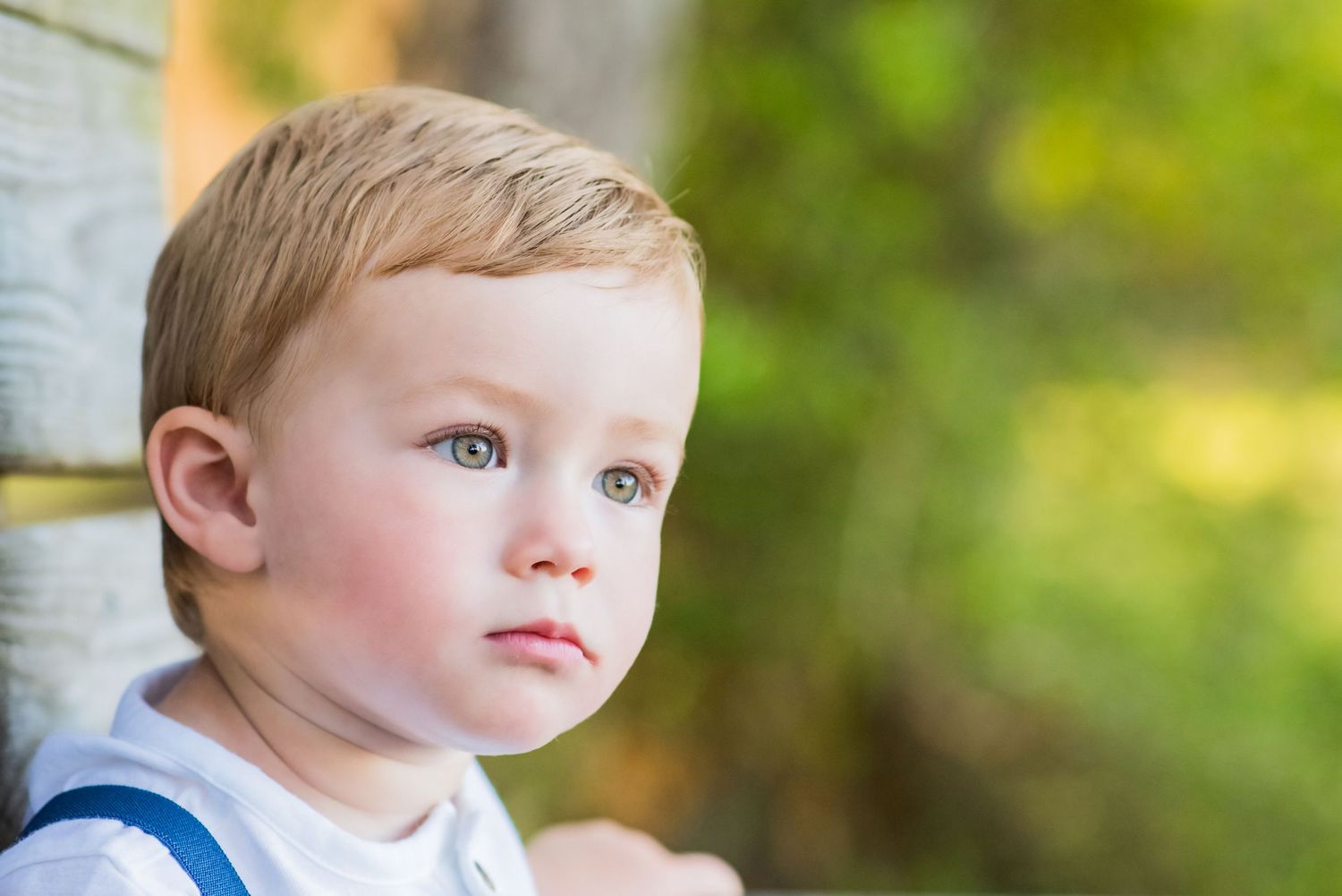 portrait of toddler sitting on bench on Panama City Beach Florida during a child portrait photoshoot