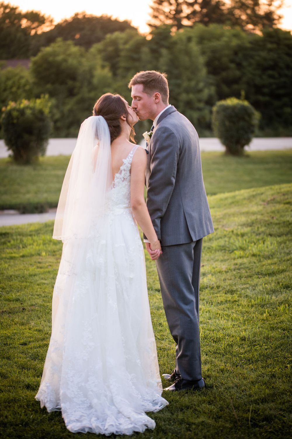 Bride and groom kissing at golden hour at Stratford Country Club wedding