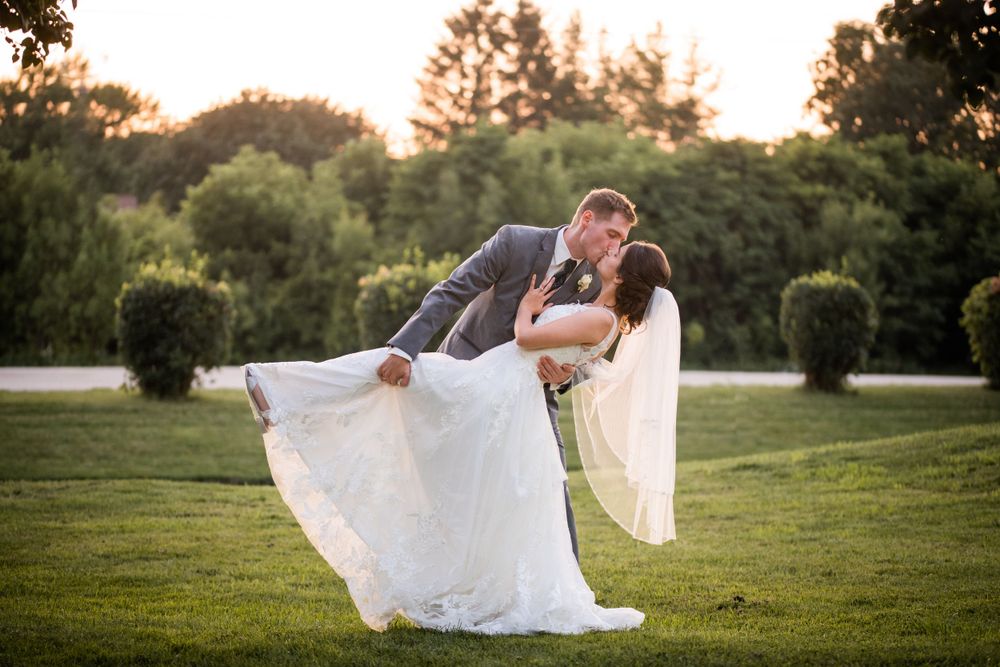 Bride and groom dip kiss at golden hour at Stratford Country Club wedding