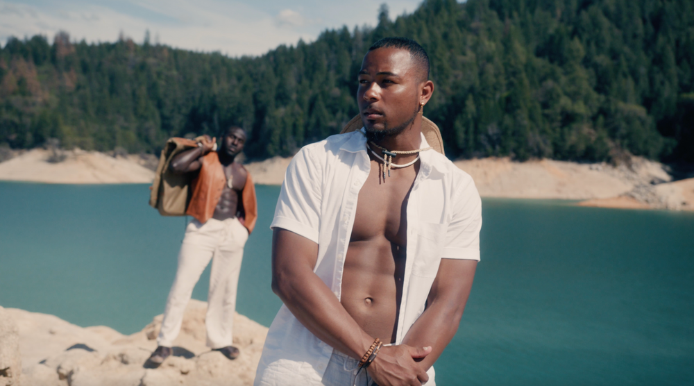 Two male athletic models with shirt off on the lakeside in video shoot