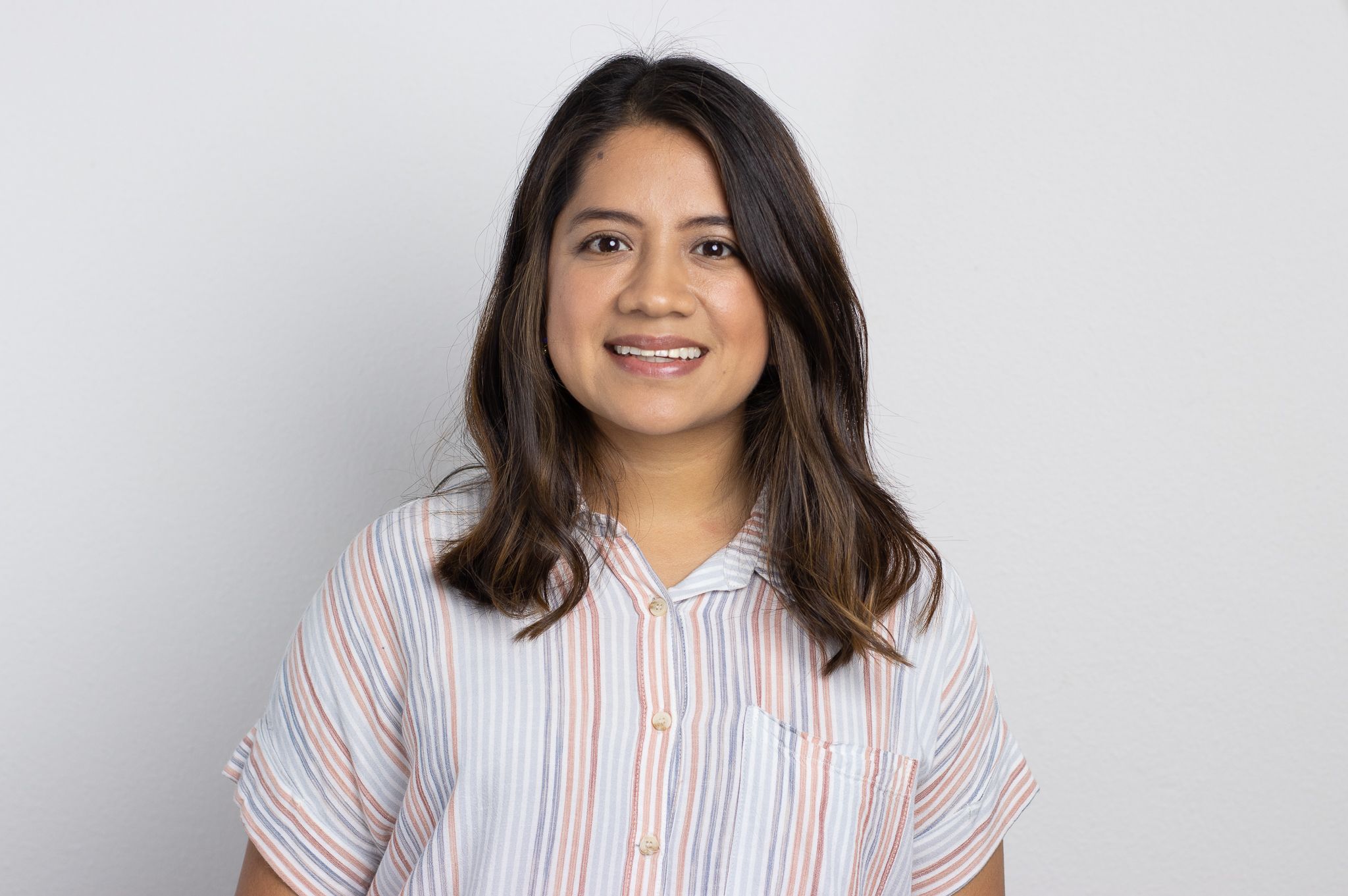 Portrait sequence showing woman in striped shirt against white background.