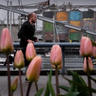 Vancouver jogger runs along False Creek during Spring hail storm