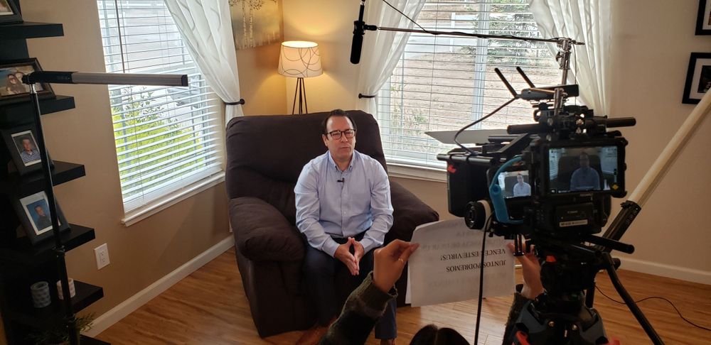 Behind the scenes of interview setup with professional camera and lighting equipment.