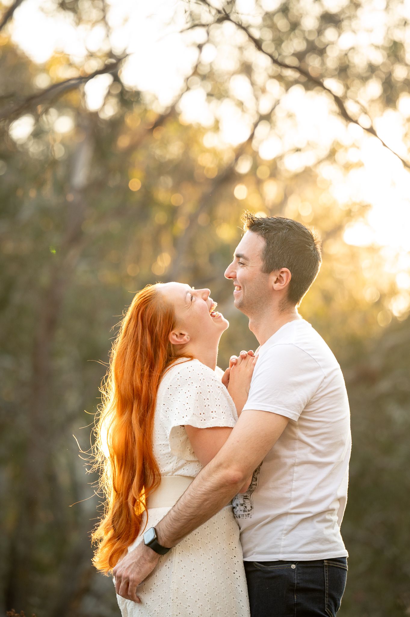Husband and wife enjoying golden hour laughing with each other