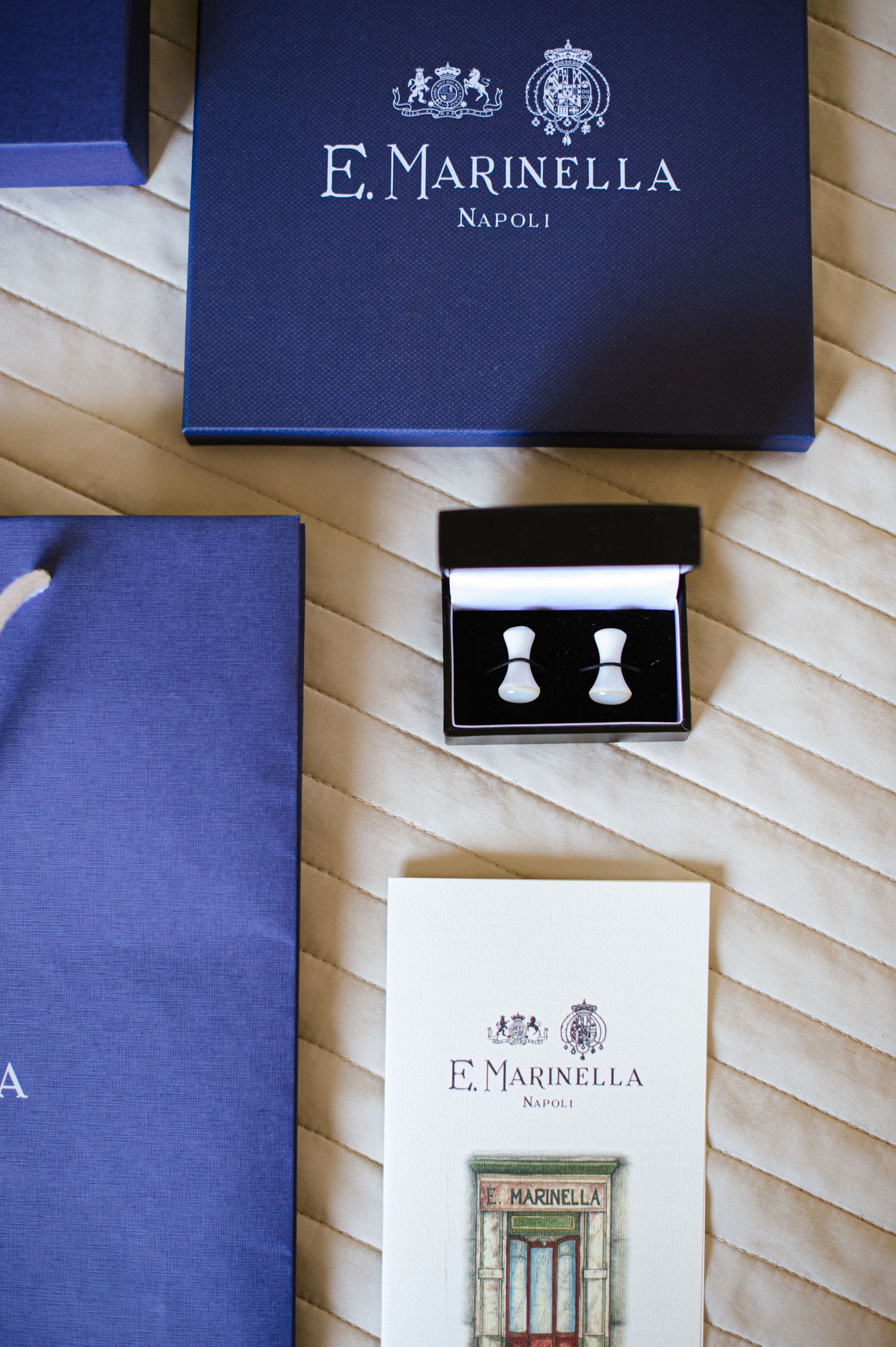 E. Marinella Napoli luxury brand jewelry box with bow-shaped silver cufflinks and branded packaging.