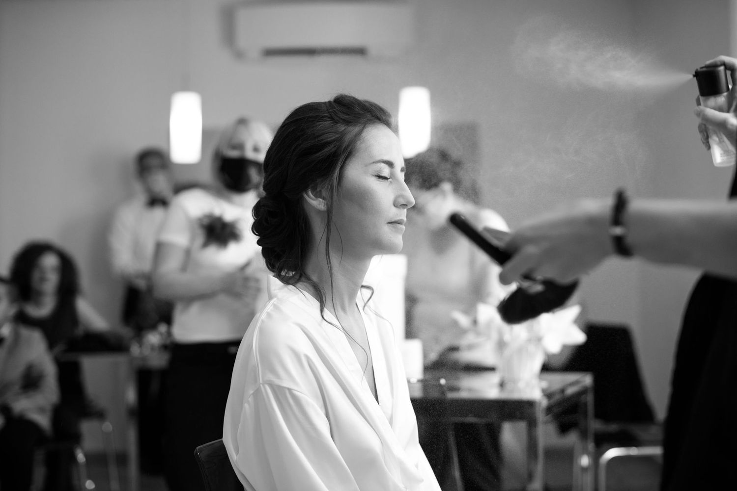 Black and white image of serene moment during wedding preparations.