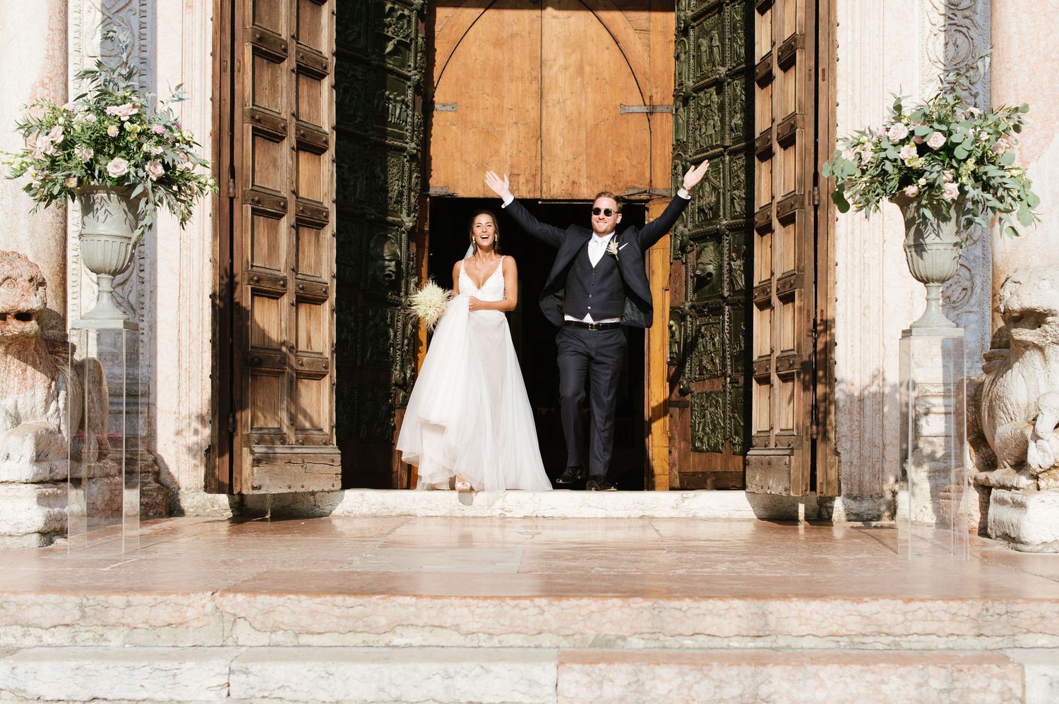 A black and white photo captures a celebratory moment with confetti flying around a couple.