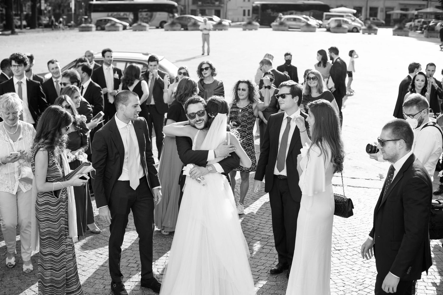 Wedding guests socialize and celebrate at an outdoor gathering.