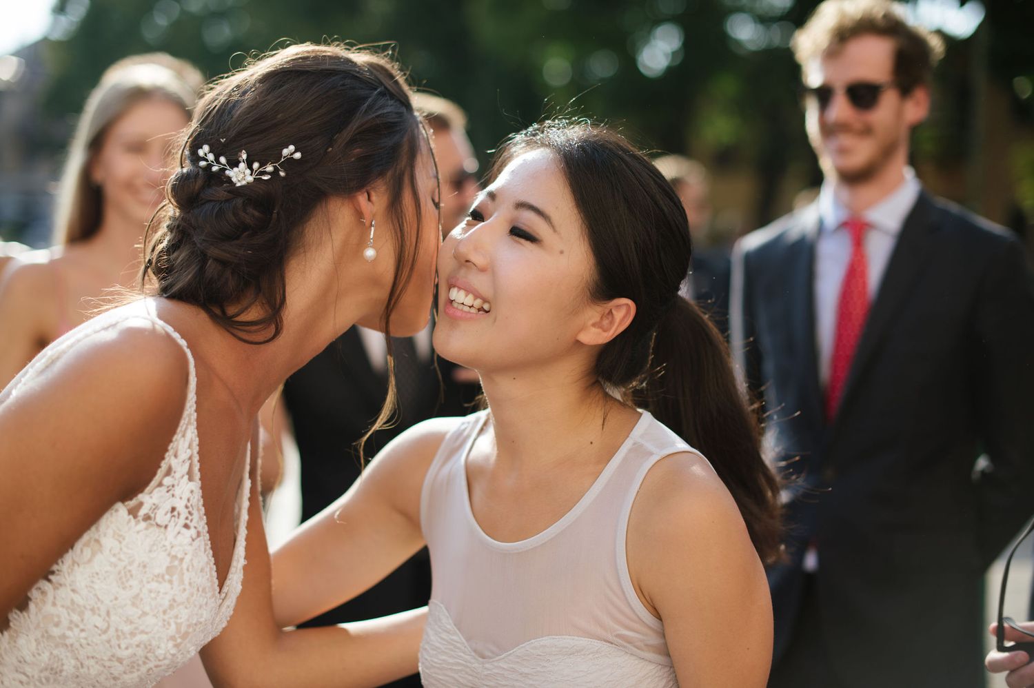 Two people sharing an intimate moment at an outdoor wedding celebration.