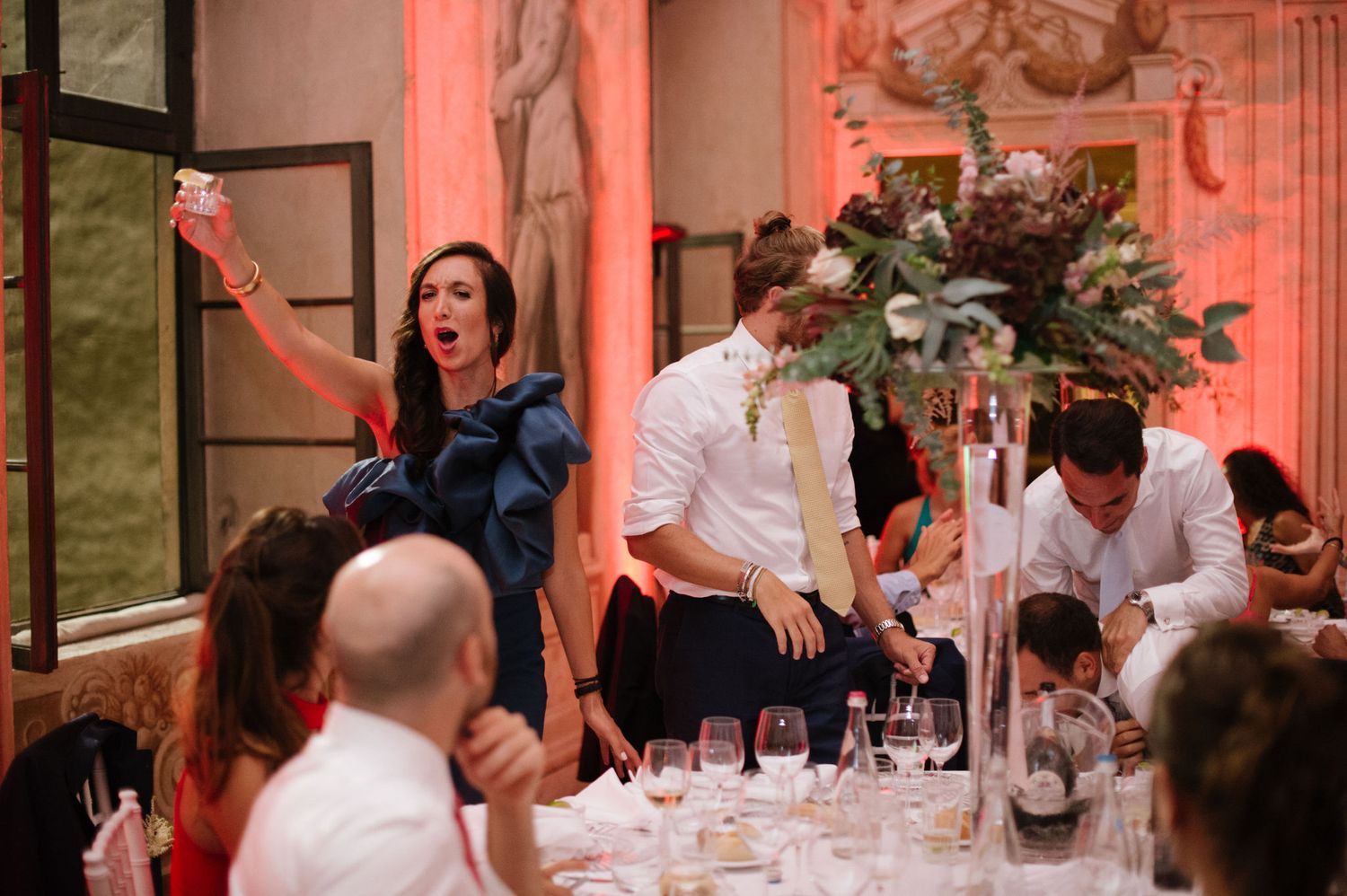 Wedding guests celebrating and dancing during reception in historic Italian villa.