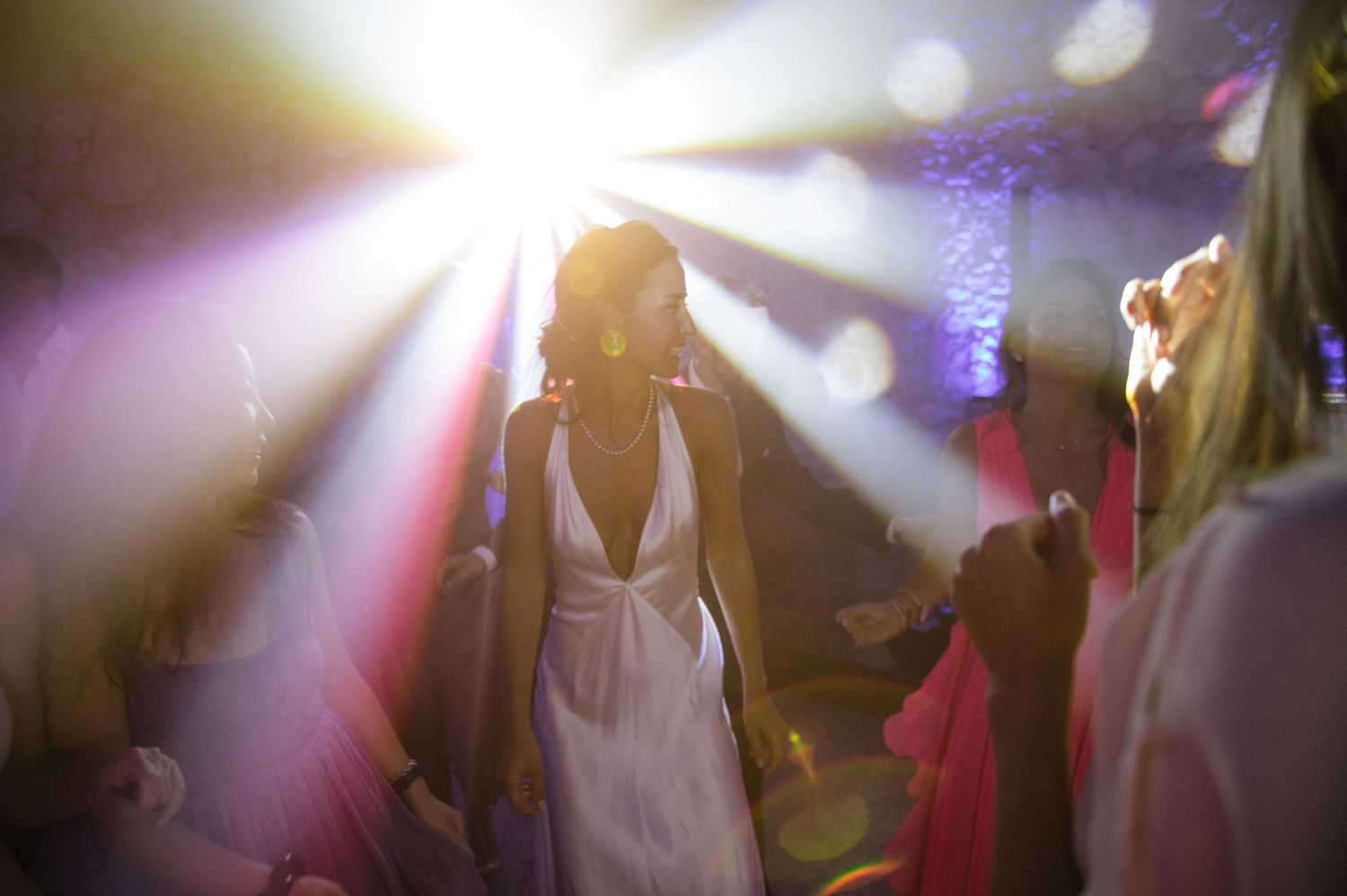 Dreamy dance floor scene with soft white spotlights and ethereal lighting effects.