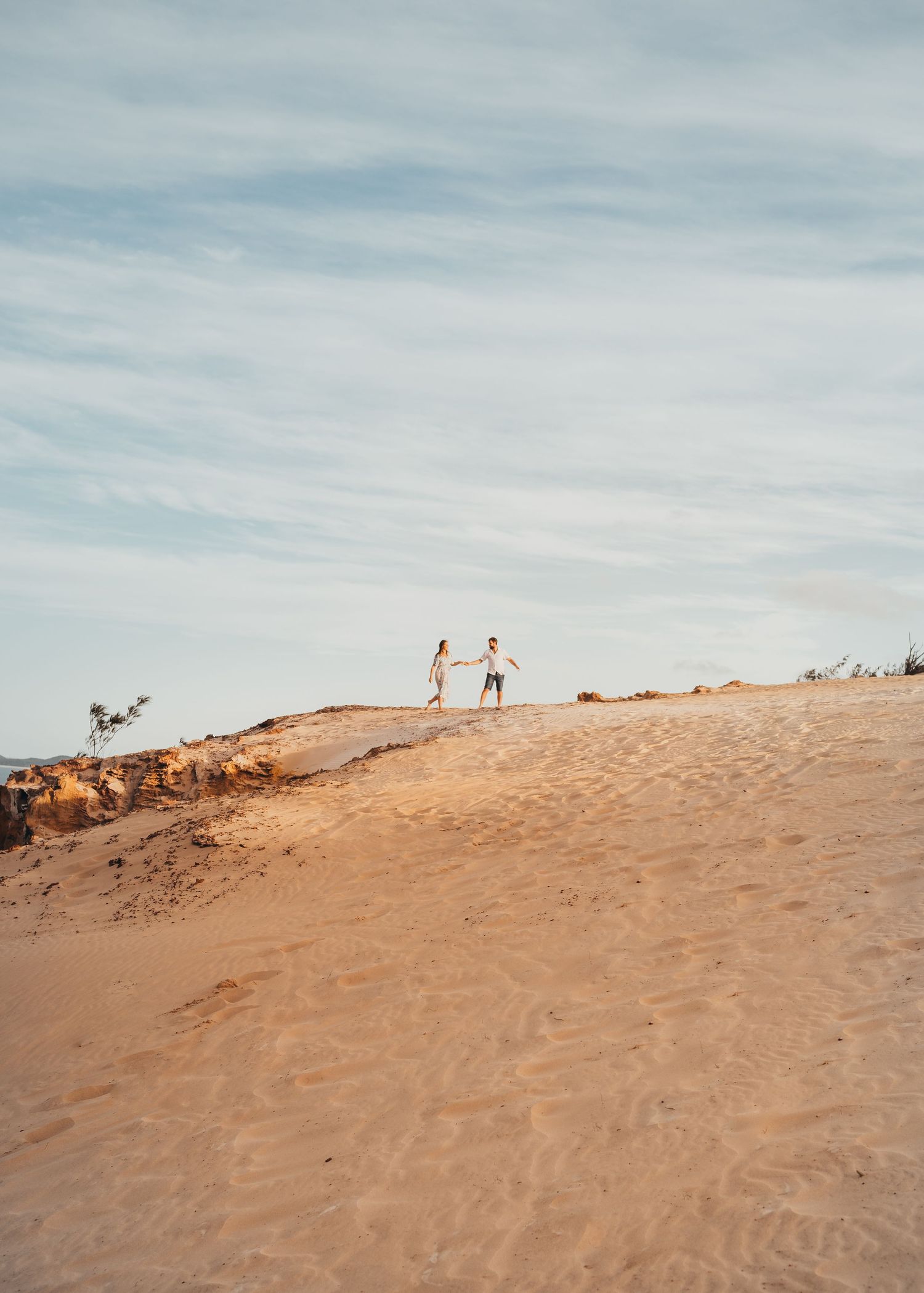 Celebrating their love with an engagement session atop Carlo Sandblow, Queensland at Rainbow Beach, QLD