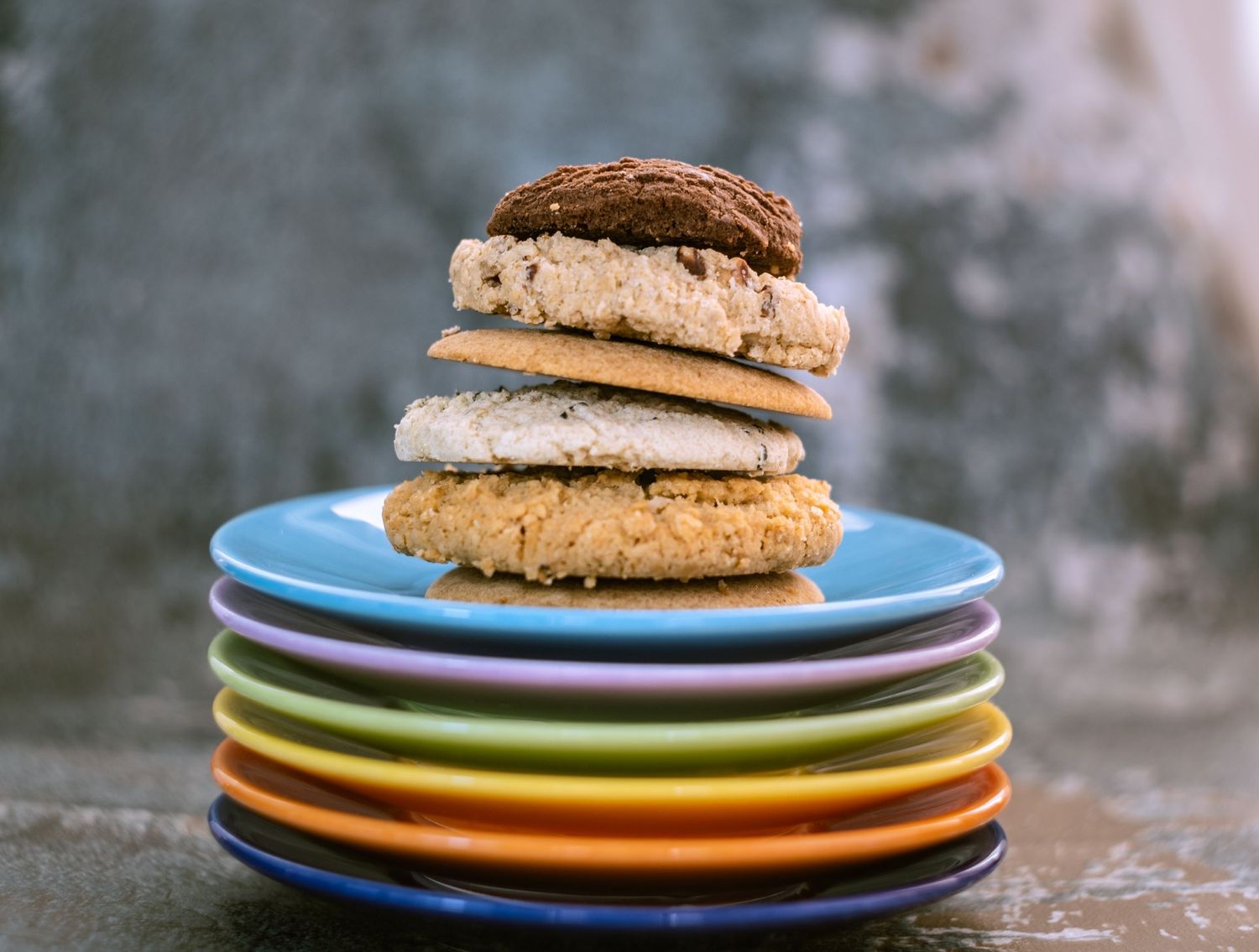 stack of biscuits on a stack of colourful plates
