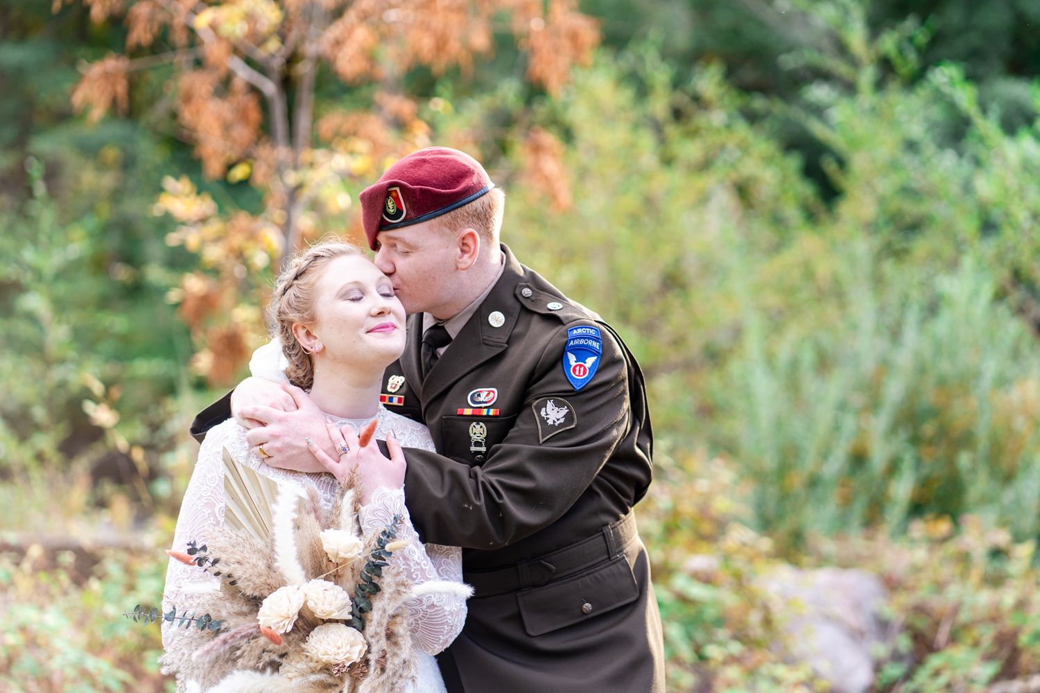 groom kisses bride on forehead