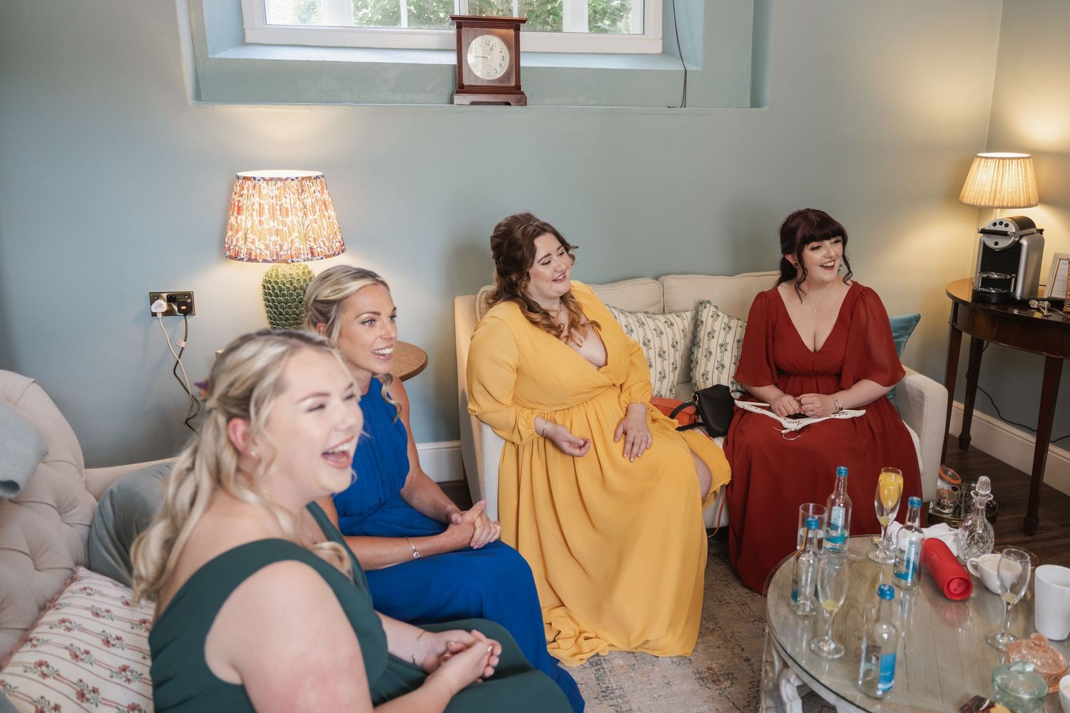 Group gathered on couch wearing formal attire in blue and yellow dresses.