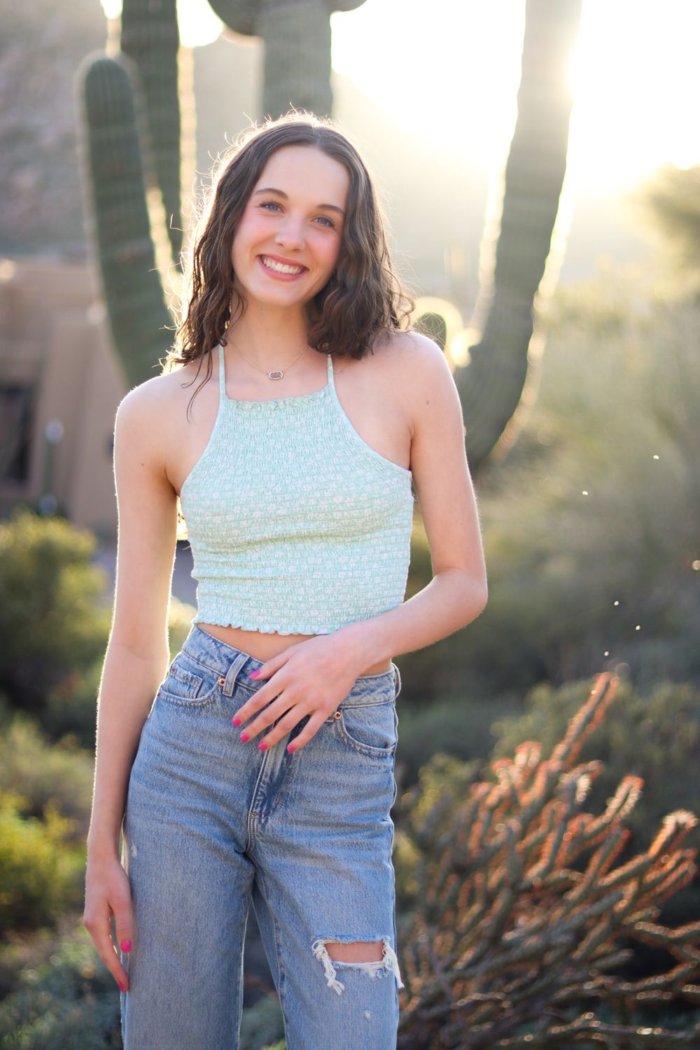 Senior girl poses in front of a cactus by Breckenridge photographer, Britt Sheafe