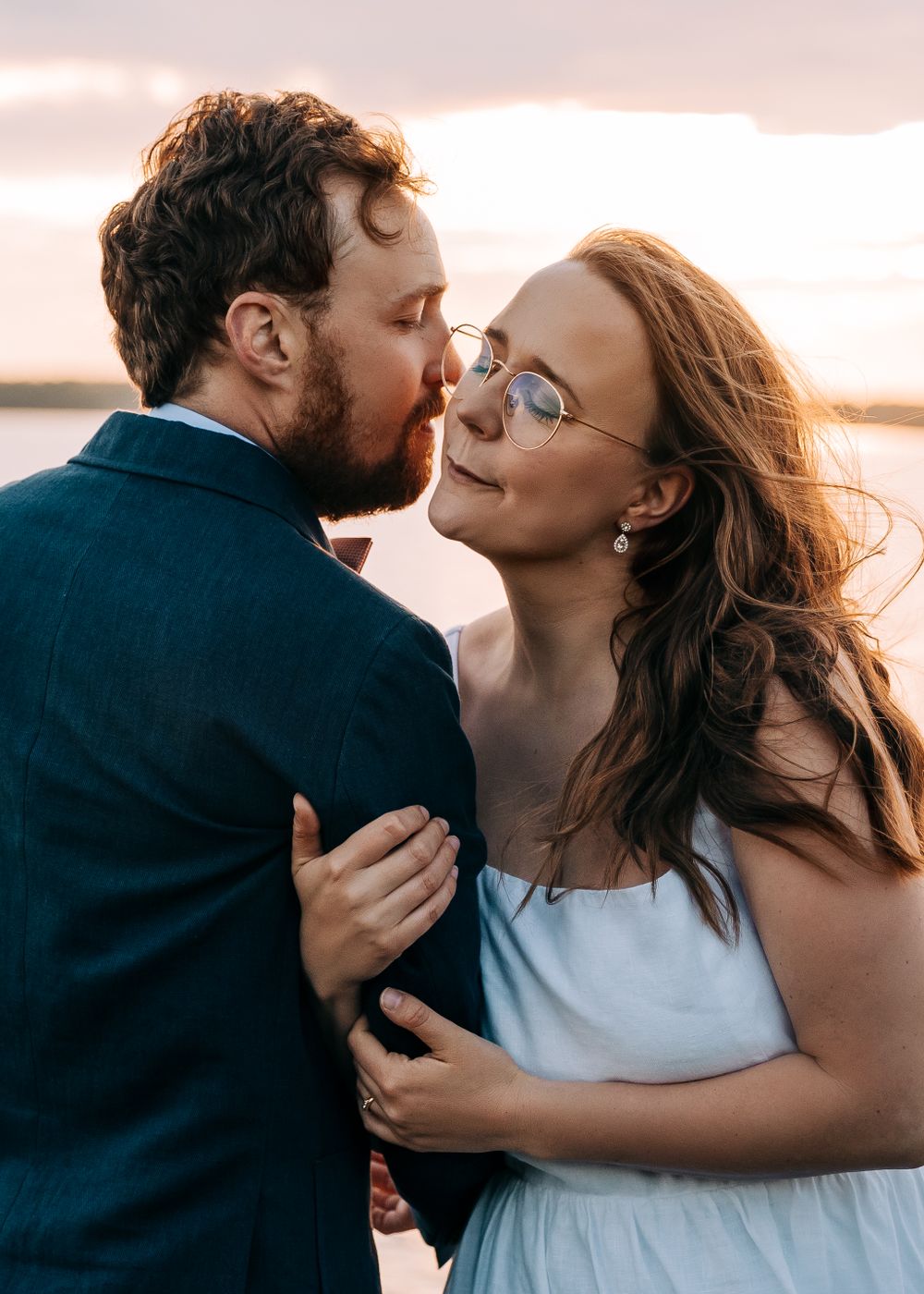 Intimate moment captured during golden hour by the sea.