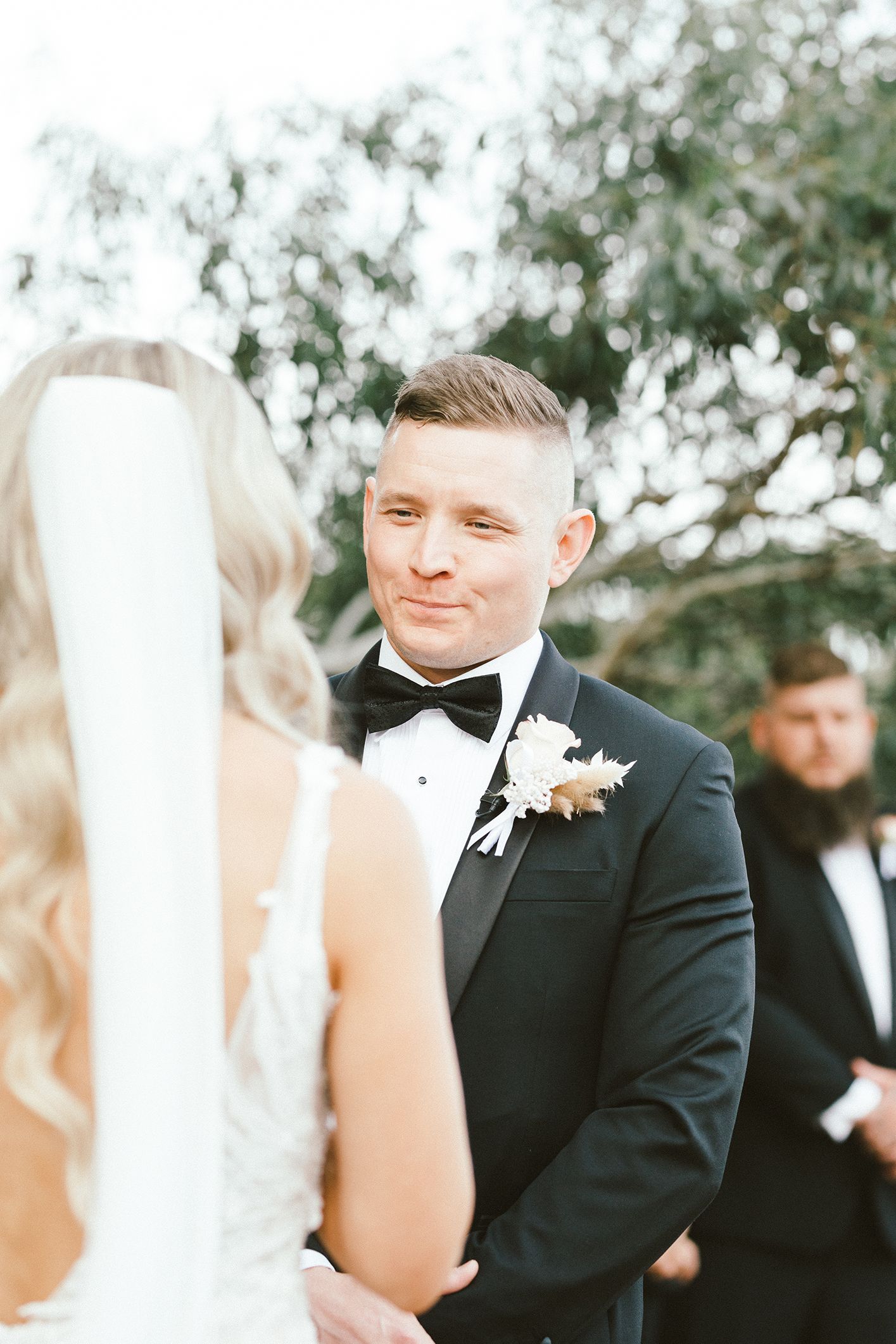 A wedding ceremony moment showing emotion from the groom during an outdoor wedding.