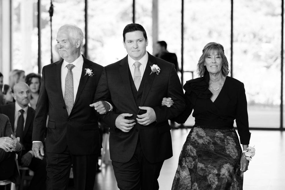 Groom and his parents was down aisle during wedding ceremony at Jorgensen Farms in Westerville, Ohio.