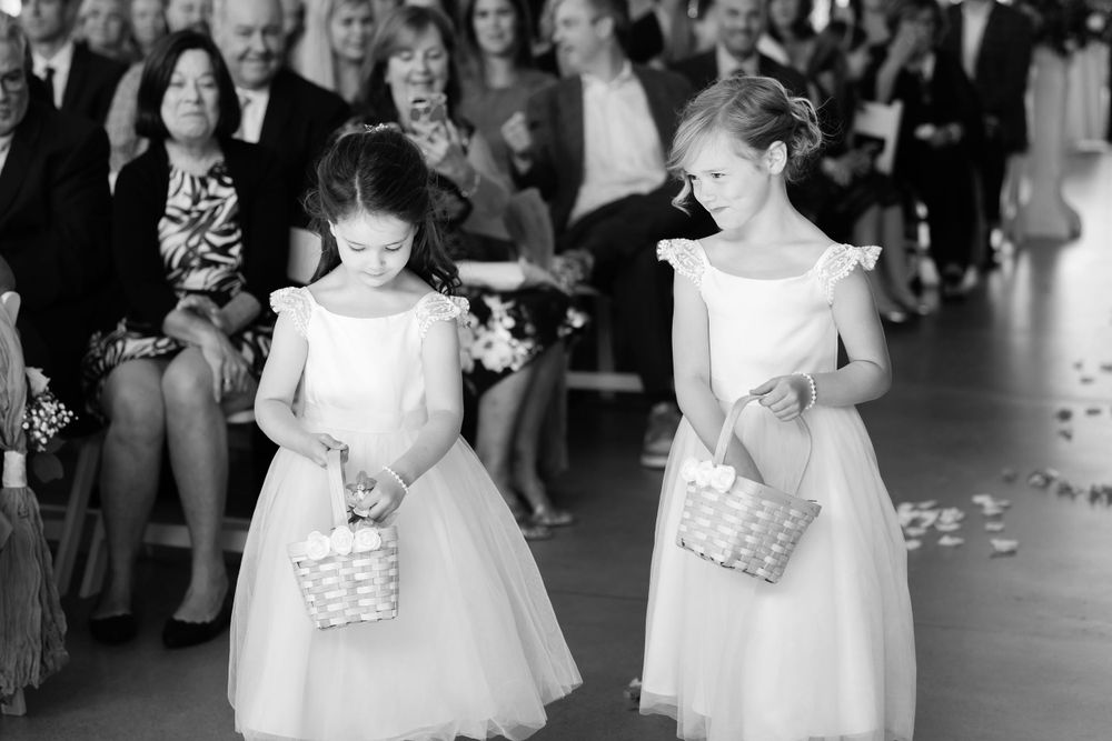 Flower girls walk down aisle during wedding at Jorgensen Farms in Westerville, Ohio.