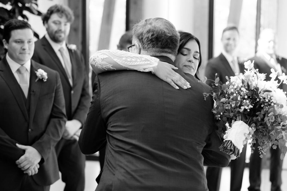 Bride and her father hug during wedding ceremony at Jorgensen Farms in Westerville, Ohio.