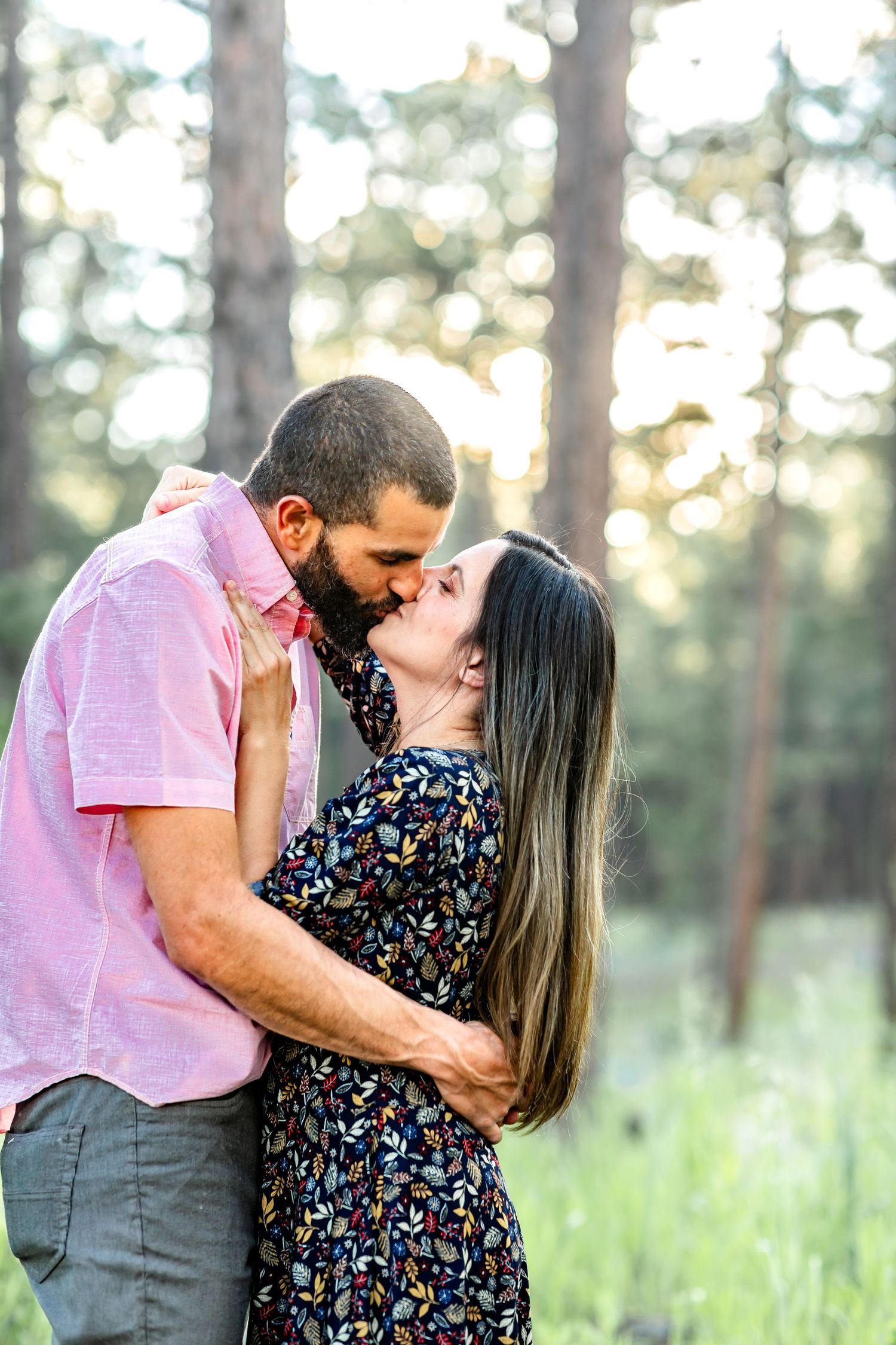 Husband and wife kiss at sunset during their family session in Colorado Springs.