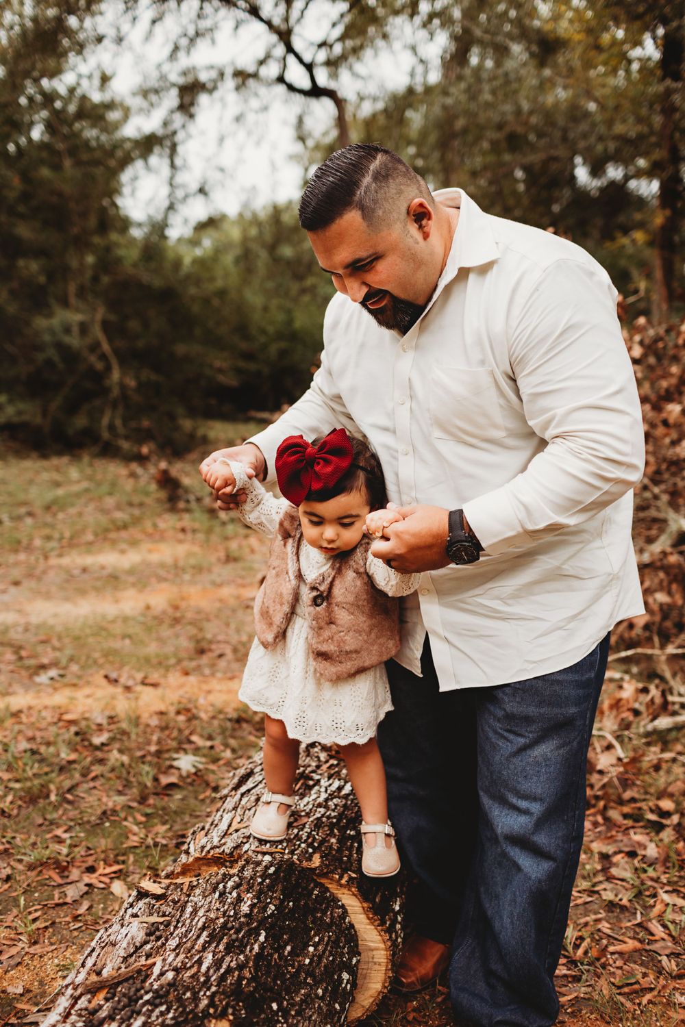 Daddy holding daughters hands walking