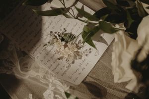 Handwritten note with floral elements and delicate details in vintage style.