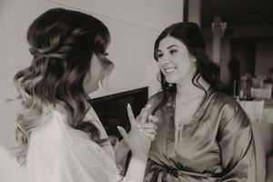 Two people in robes sharing a moment during wedding preparations.