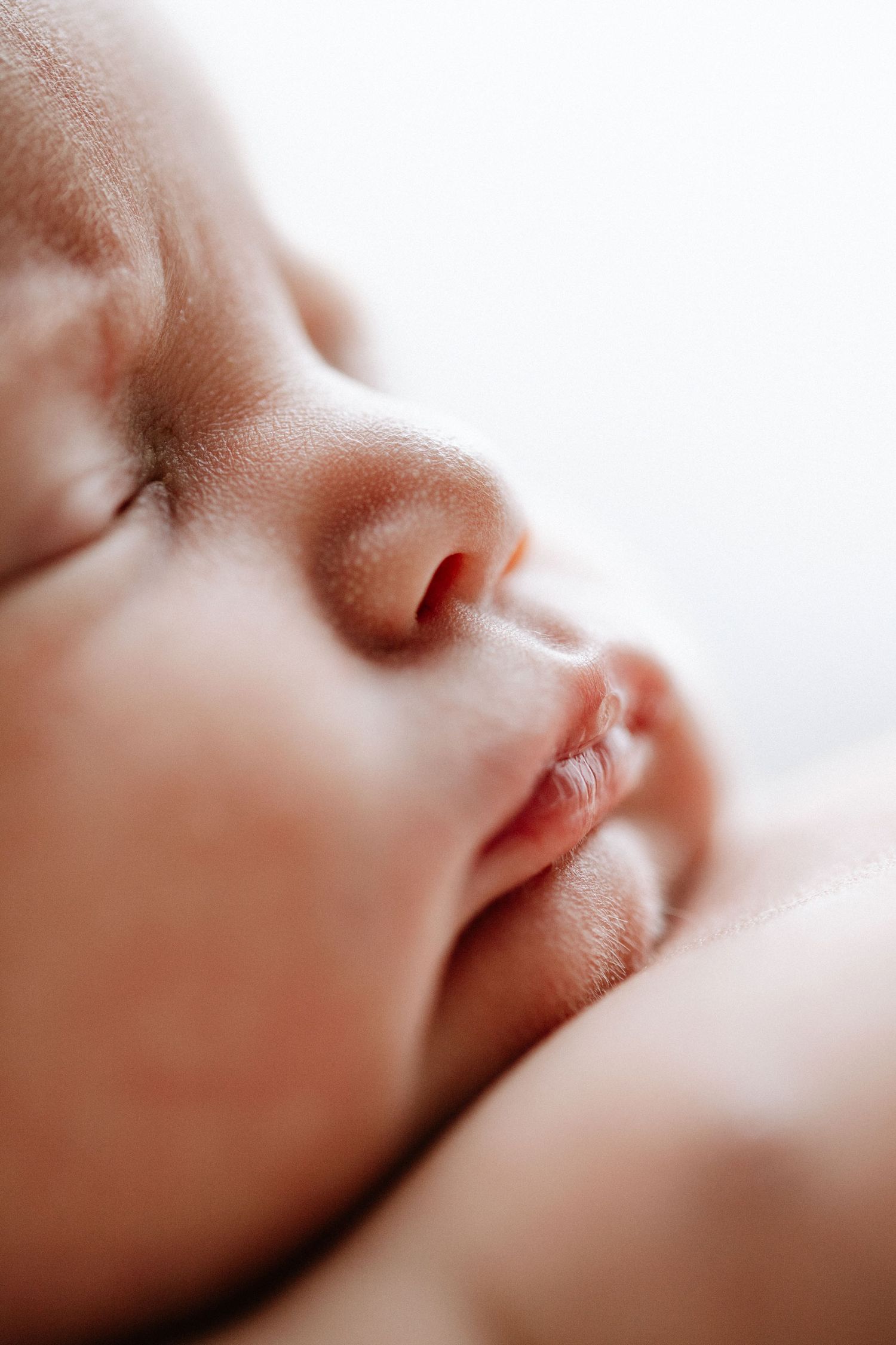 Close-up macro shot of sleeping baby's face showing delicate features.