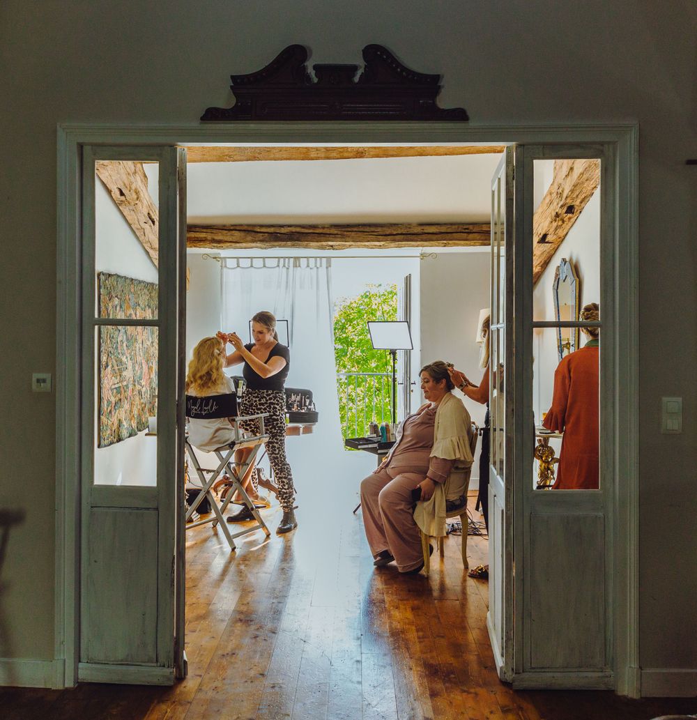 Interior doorway view of wedding preparations in rustic venue.