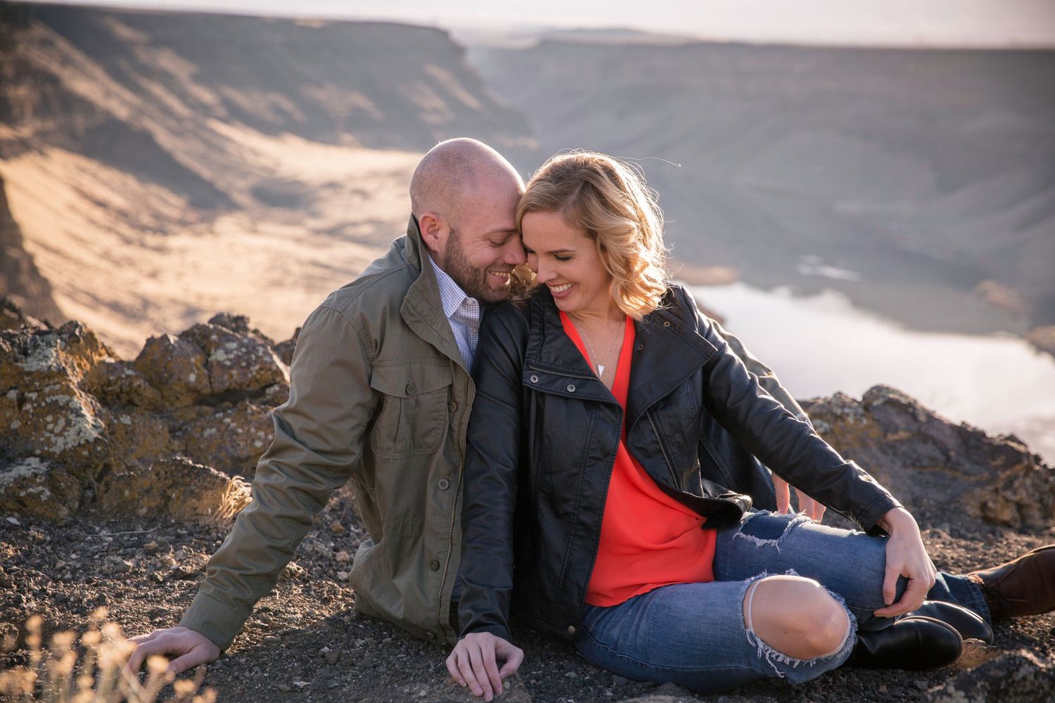 Logan and Jamie snuggling together on the over look at Swan Falls for their engagement photos.