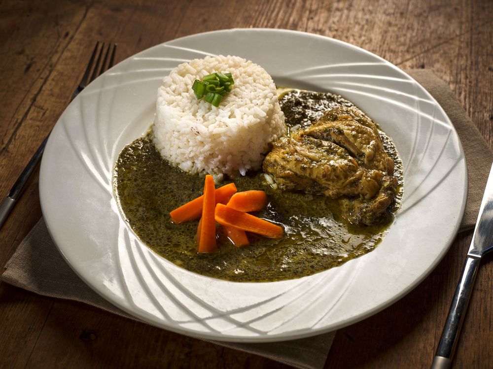 Progression of curry dishes with white rice and garnishes plated on white dishes.